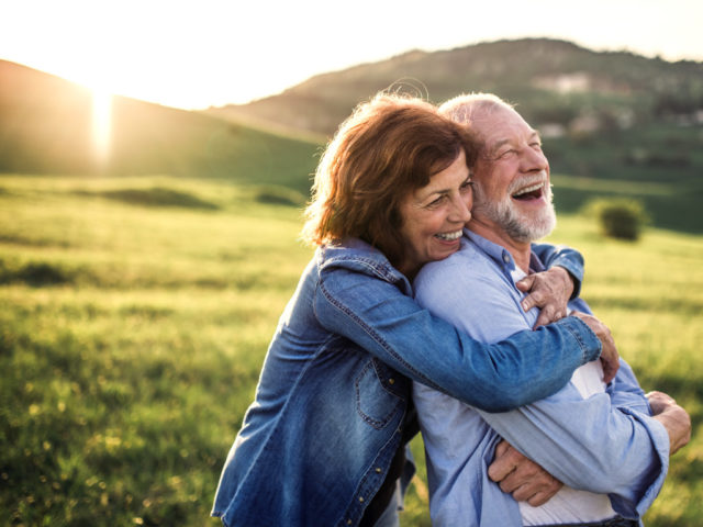 Couple smiling together outdoors, Elk Run Assisted Living in Evergreen, CO