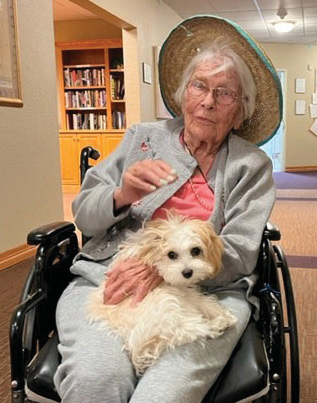 Elk Run resident enjoys the friendship of a visiting dog.