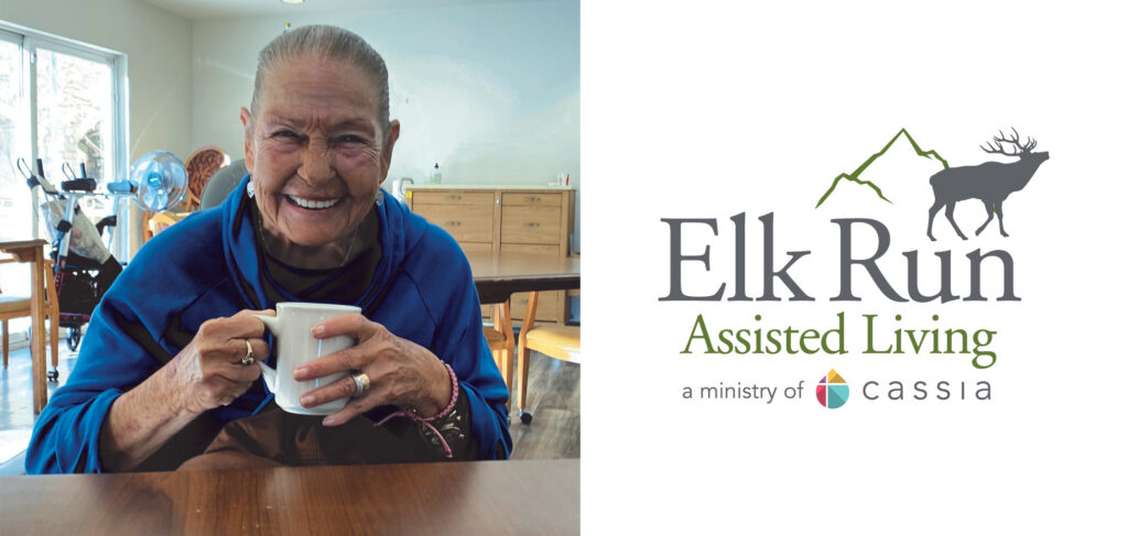 Bettie holds a coffee mug and smiles, Elk Run Assisted Living in Evergreen, CO