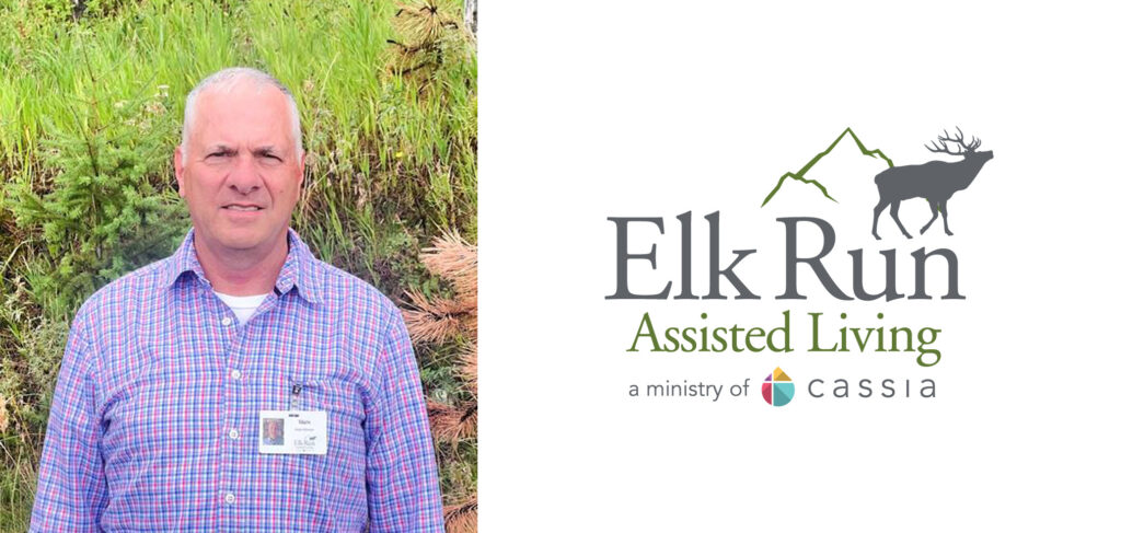 Mark Rose, the new sales director at Elk Run Assisted Living, standing outdoors in front of green foliage. The Elk Run Assisted Living logo is also shown.